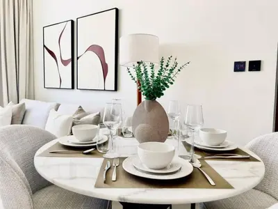 a dining room table with a vase on top of it at Aesthetic 1br In Binghatti House Free Pool Gym in Dubai