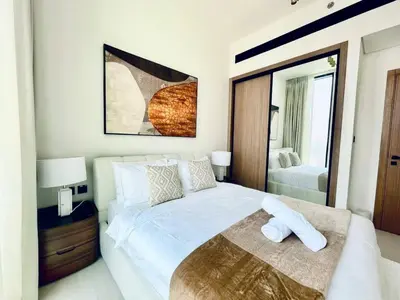 a bedroom with a large white bed and a mirror at Aesthetic 1br In Binghatti House Free Pool Gym in Dubai