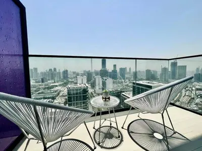 a balcony with chairs and a view of a city at Aesthetic 1br In Binghatti House Free Pool Gym in Dubai