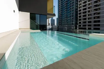 a swimming pool on the roof of a building at Velvet 1br Serenity Pool View & Free Amenities! in Dubai
