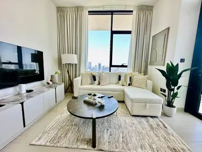 a living room with a couch and a table at Sky 2br Sanctuary With Plunge Pool Gym Parking! in Dubai