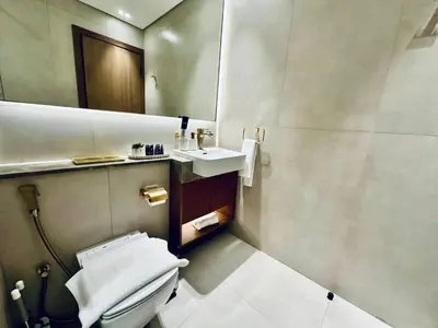 a bathroom with a toilet and a sink at Sky 2br Sanctuary With Plunge Pool Gym Parking! in Dubai