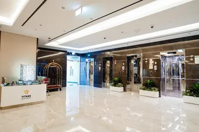 a lobby of a fashion store with potted plants at Luxury Studio Pool & Gym Access in Dubai Sports City in Dubai
