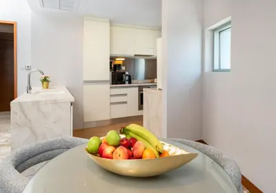 a bowl of fruit on a table in a kitchen at Fashion Avenue Dubai Mall in Dubai