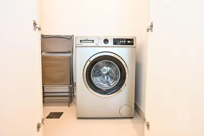 a washer and dryer in a room at Luxury 2 Bedroom Apartment - Private Beach - Emaar Beach Vista in Dubai