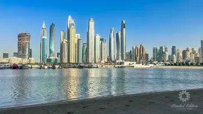 a view of a large city with a body of water at Luxury 2 Bedroom Apartment - Private Beach - Emaar Beach Vista in Dubai