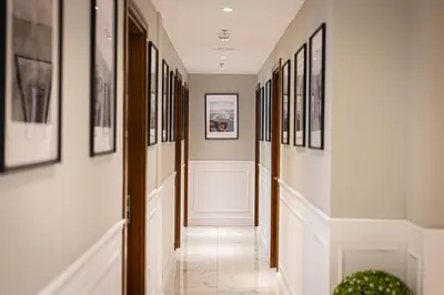 a hallway with paintings and pictures on the walls at Luxury 4BHK in Business Bay w Burj Khalifa View Noora 4203 in Dubai