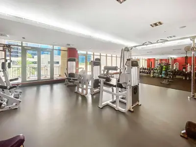 a gym with several treadmills and machines at Silkhaus Luxurious 1BDR in Downtown in Dubai