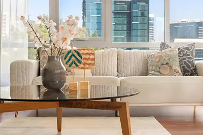 a living room with a couch and a coffee table at Silkhaus Luxurious 1BDR in Downtown in Dubai
