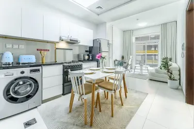 a kitchen with a table and chairs in a room at FAM Living 1BR Stay Binghatti Gateway, Al Jaddaf in Dubai