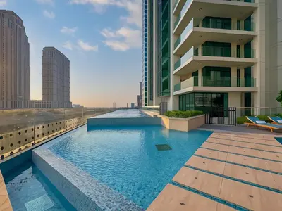 a swimming pool on the roof of a building at Luxury Studio in Urban Oasis, Business Bay in Dubai