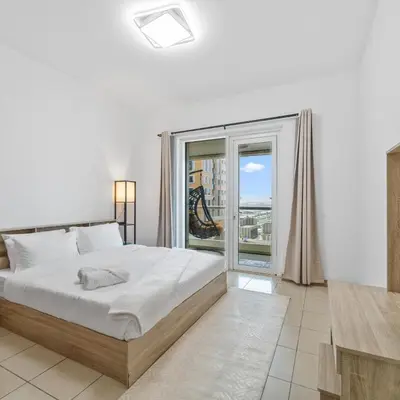 a bedroom with a large bed and a large window at 1BR in Sulafa Tower- Ideal for Short-Term Stay in Dubai