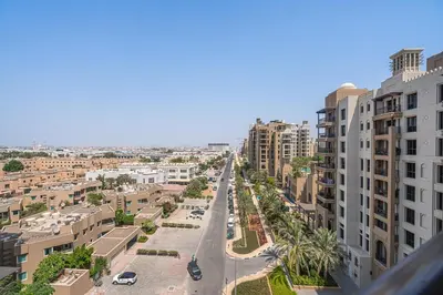 a view of a street in a city with buildings at Serene 1BR Stay with Pool, Gym, & Kids Playground in Dubai