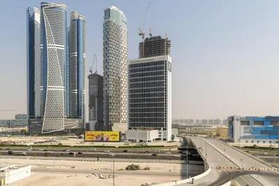 a group of tall buildings in a city with a highway at Waves - Impressive 1BR Apartment Close to Burj Khalifa in Dubai