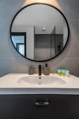 a bathroom sink with a large mirror above it at Waves - Impressive 1BR Apartment Close to Burj Khalifa in Dubai