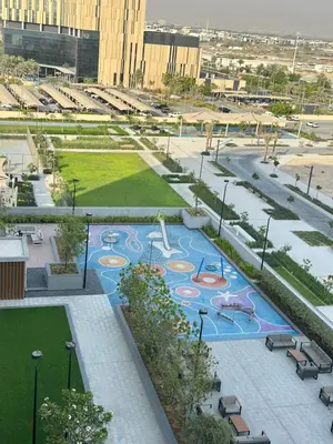 an aerial view of a park with a playground at Luxury 1BR Hills Green View Mall & Downtown Dining Shopping in Dubai