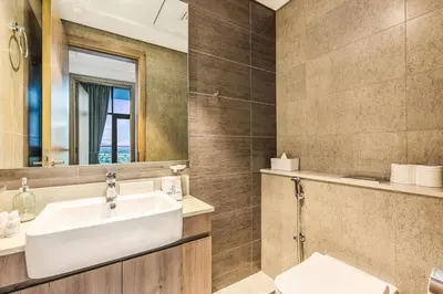 a bathroom with a sink and a mirror at Luxury 1BR Hills Green View Mall & Downtown Dining Shopping in Dubai