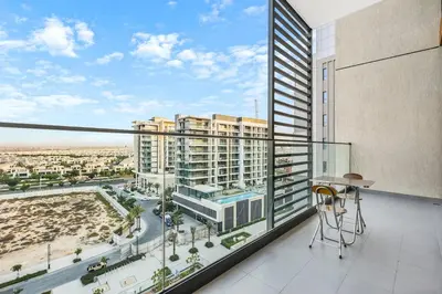 an apartment balcony with a view of a city at Luxury 1BR Hills Green View Mall & Downtown Dining Shopping in Dubai