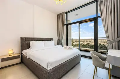 a bedroom with a bed and a large window at Luxury 1BR Hills Green View Mall & Downtown Dining Shopping in Dubai