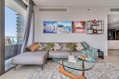 a living room with a couch and a glass table at DAYF-MGA Spacious 3Bed with Full Marina View in Dubai