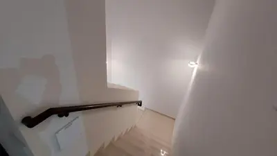a stairway with a white wall and a stair railing at Damac hills 2 vardon cluster in Dubai