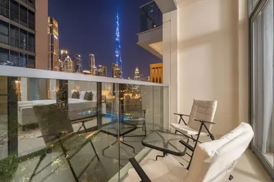 a balcony with chairs and a view of the city at FIRST CLASS 1BR Burj Views & Classy Comfort in Dubai