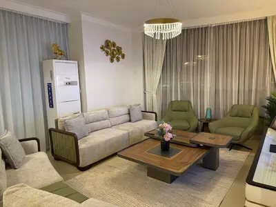 a living room with a couch and chairs and a table at 3403!Dubai SkyLine View! Royal Montania Homes in Dubai