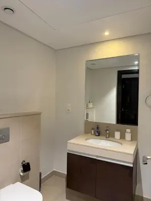 a bathroom with a sink and a large mirror at 3403!Dubai SkyLine View! Royal Montania Homes in Dubai