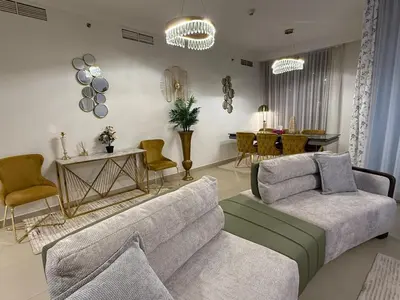 a living room with a couch and a table and chairs at 3403!Dubai SkyLine View! Royal Montania Homes in Dubai