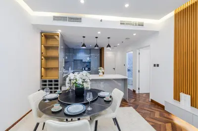 a dining room and kitchen with a table and chairs at Modern 1BR with High Floor Near Mall & Tram in Dubai