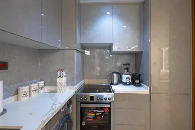 a kitchen with a stove and a counter top at Modern 1BR with High Floor Near Mall & Tram in Dubai