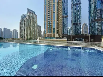 a large swimming pool in a city with tall buildings at Modern 1BR with High Floor Near Mall & Tram in Dubai