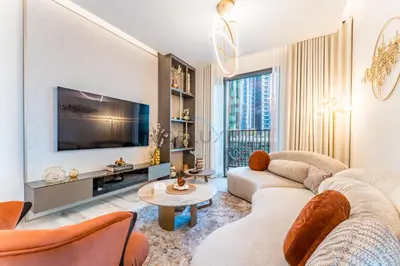 a living room with a couch and a tv at Furnished 1BR, Walk to Business Bay Metro, Near Downtown, Ahad Residences, Business Bay by Deluxe Holiday Homes in Dubai