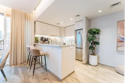 a kitchen with a counter and stools in a room at Furnished 1BR, Walk to Business Bay Metro, Near Downtown, Ahad Residences, Business Bay by Deluxe Holiday Homes in Dubai