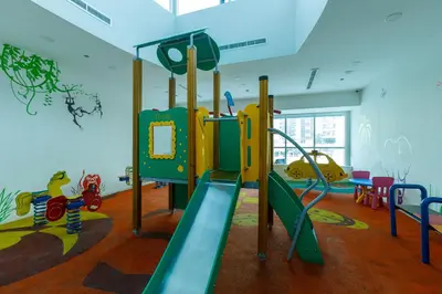 a childrens play room with a slide at Bright 1BR with Marina Views - Orra Marina - Allsopp & Allsopp in Dubai