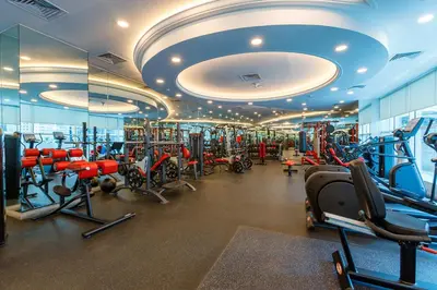 a gym with a lot of treadmills and machines at Bright 1BR with Marina Views - Orra Marina - Allsopp & Allsopp in Dubai
