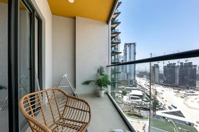 a balcony with a chair and a view of a city at Relaxing 1BR w Maids room Minutes to Dubai Mall by Vibel in Dubai