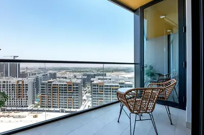 a balcony with two chairs and a table with a view at Relaxing 1BR w Maids room Minutes to Dubai Mall by Vibel in Dubai