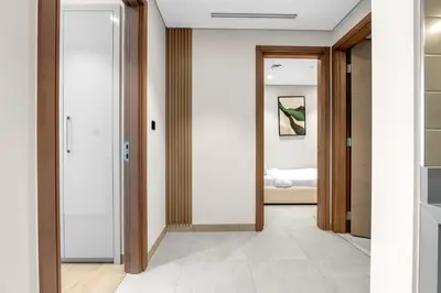 a hallway with a door leading to a bedroom at Relaxing 1BR w Maids room Minutes to Dubai Mall by Vibel in Dubai