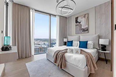 a bedroom with a large bed with a large window at Relaxing 1BR w Maids room Minutes to Dubai Mall by Vibel in Dubai