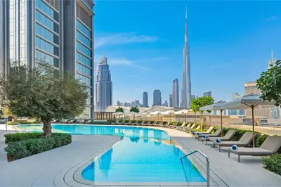 a swimming pool with a city skyline in the background at Luxurious 1BR Dubai Mall Burj Khalifa View pool in Dubai