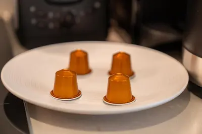 a white plate with four orange cones on it at Luxurious 1BR Dubai Mall Burj Khalifa View pool in Dubai