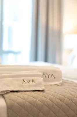 two towels are sitting on top of a bed at Luxurious 1BR Dubai Mall Burj Khalifa View pool in Dubai