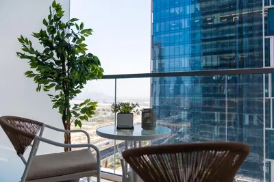 a table and chairs in a room with a window at Luxurious 1BR Dubai Mall Burj Khalifa View pool in Dubai