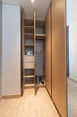 a room with a closet with wooden doors at Luxurious 1BR Dubai Mall Burj Khalifa View pool in Dubai