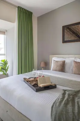 a bed with a tray with a laptop on it at Frank Porter - B324 - 5112 Elite Residence in Dubai