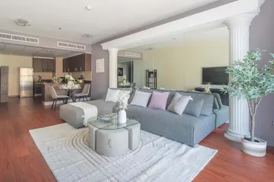a living room with a couch and a table at Frank Porter - B324 - 5112 Elite Residence in Dubai
