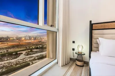 a bedroom with a window with a view at FIRST CLASS 1BR Modern Majesty in Dubai Hills in Dubai