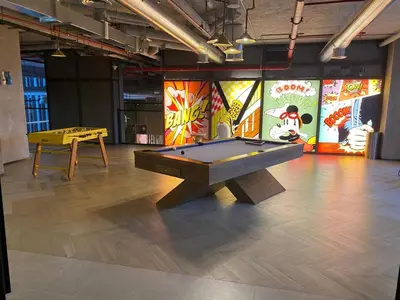 a ping pong table in a room with a pool table at FIRST CLASS 1BR Modern Majesty in Dubai Hills in Dubai