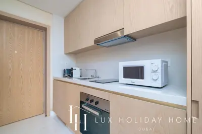 a kitchen with a microwave oven and a counter top at LUX Iconic Views at The Palm Tower Studio 3 in Dubai